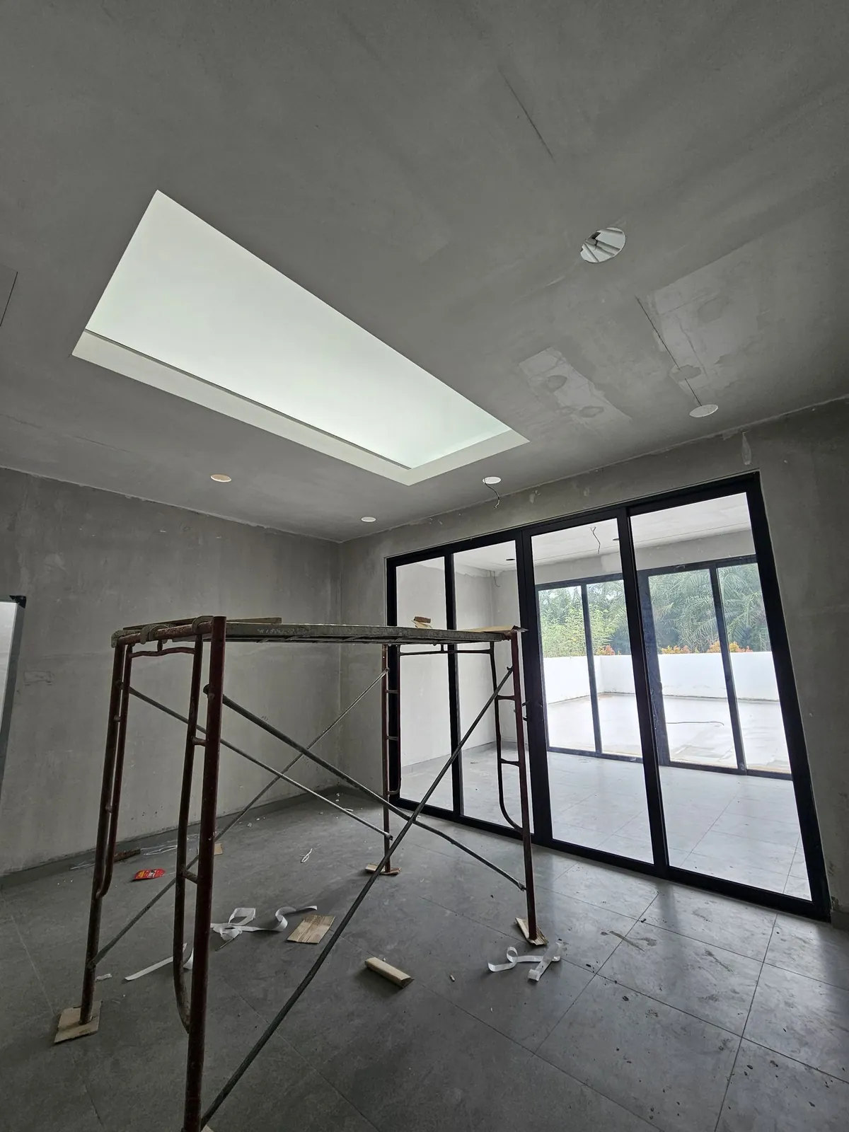 Jasin Parkland extension interior with skylight, sliding doors and a scaffold tower