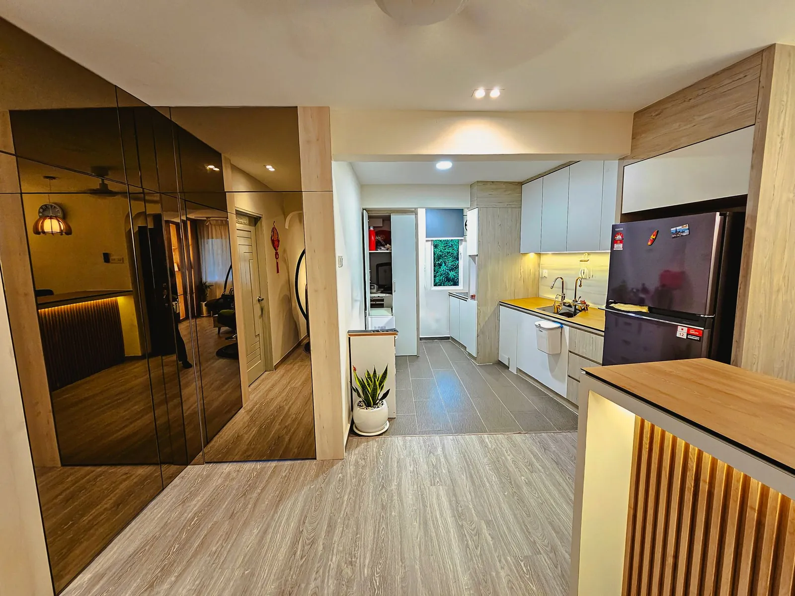 Taman Kesidang after, tinted-glass wardrobe panels and view to the white kitchen