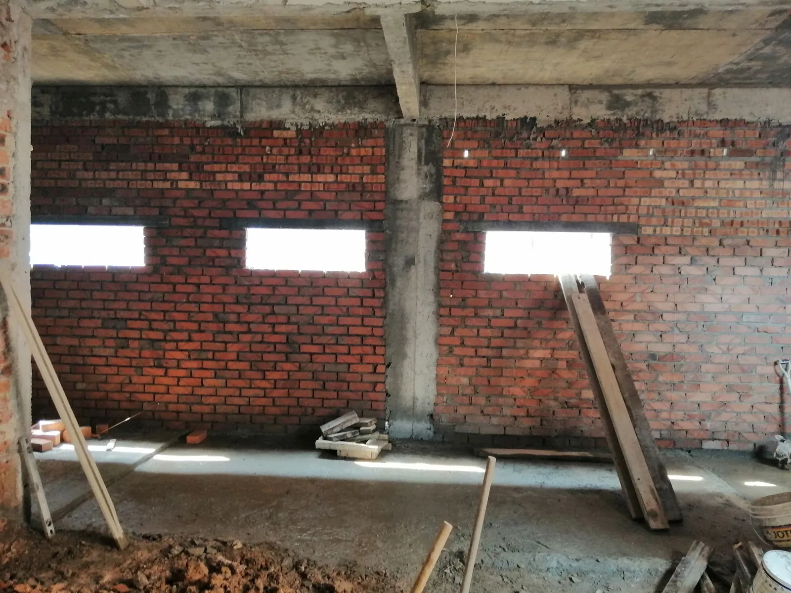 Taman Ara Permai extension brick wall with three window openings