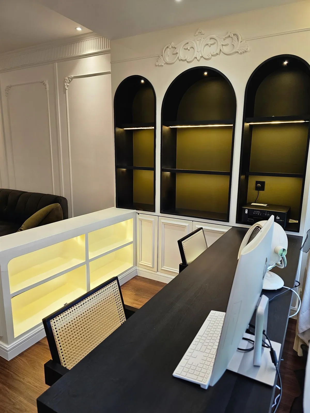 Bali Residence study corner with arched black shelving and a lit low cabinet