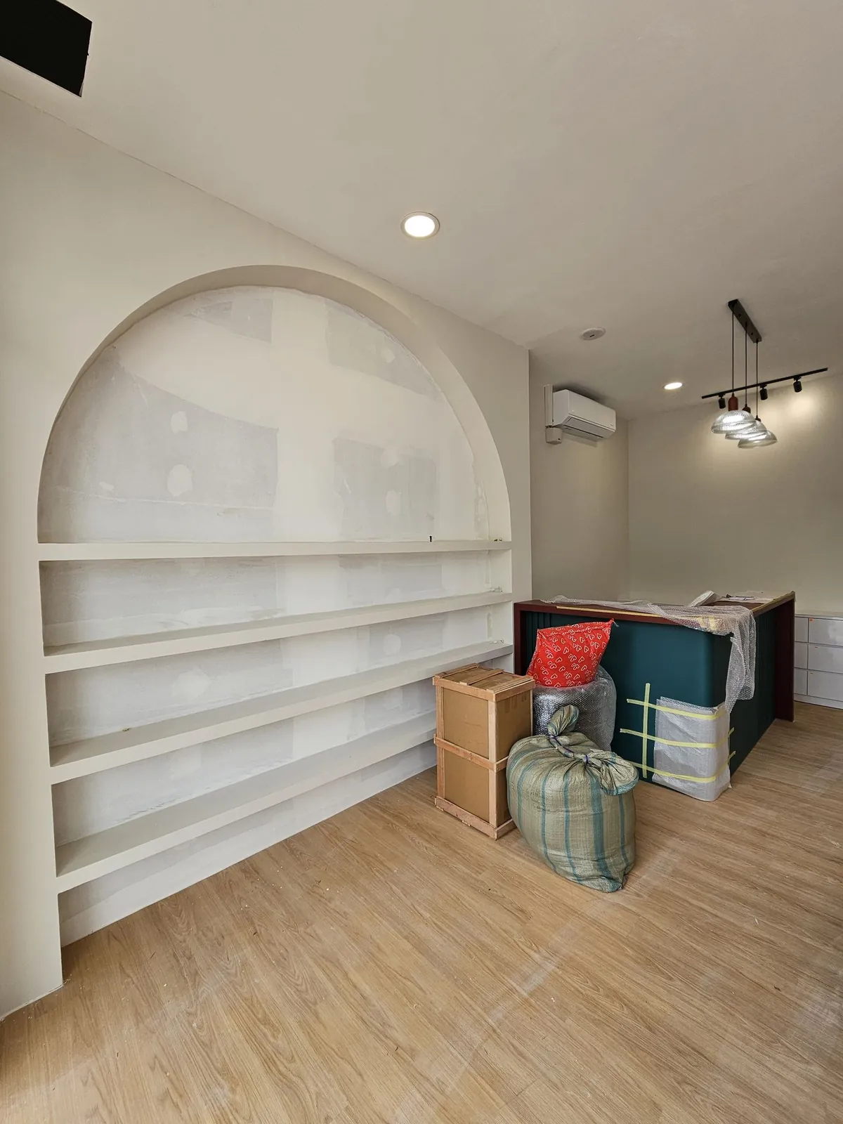 Good Skin Bar painted arched shelving and wrapped teal counter