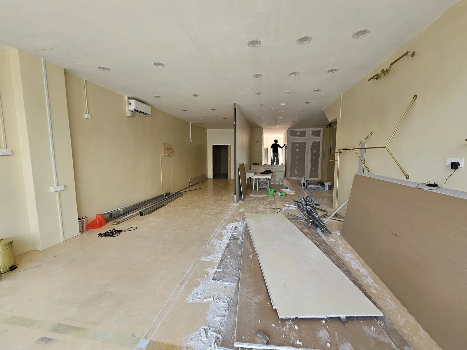 Good Skin Bar long interior with ceiling done, gypsum boards on floor