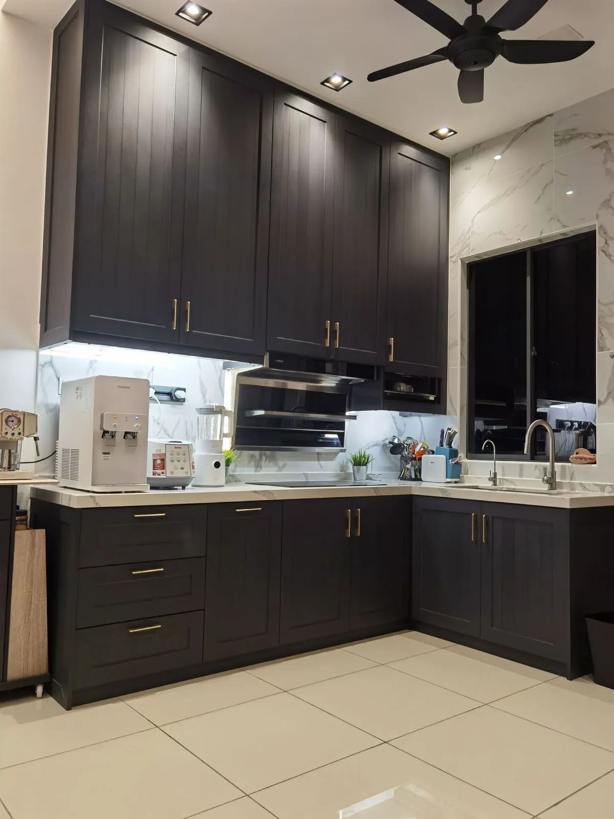L-shaped kitchen with dark shaker-style cabinets and gold handles, Country Villa