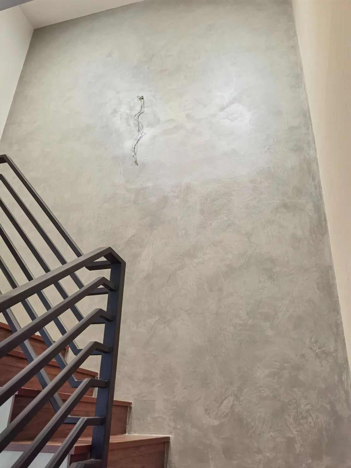 Taman Ara Permai grey cement-look staircase wall during works, wiring not yet finished