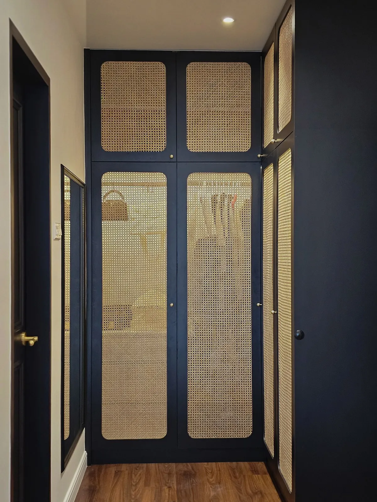 Bali Residence walk-in wardrobe with black-framed rattan-cane doors