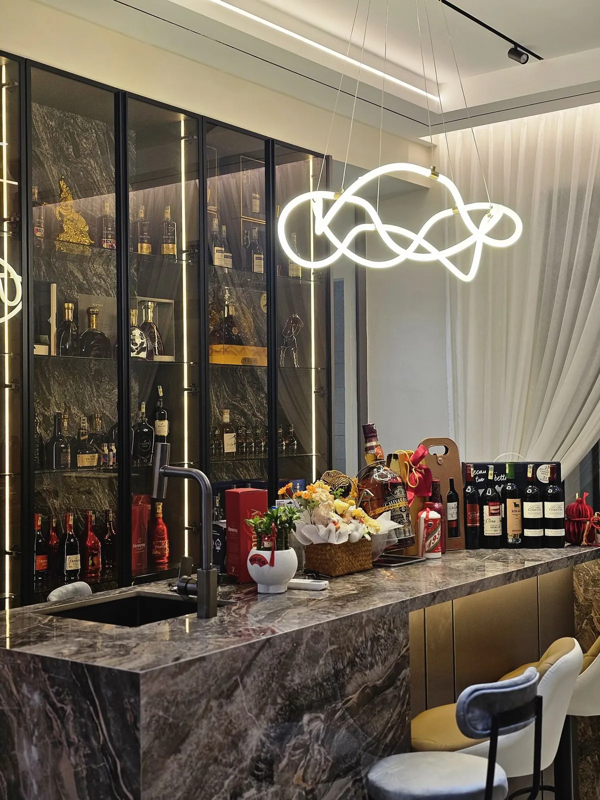 Stone-look bar counter with full-height lit glass display cabinets, Country Villa