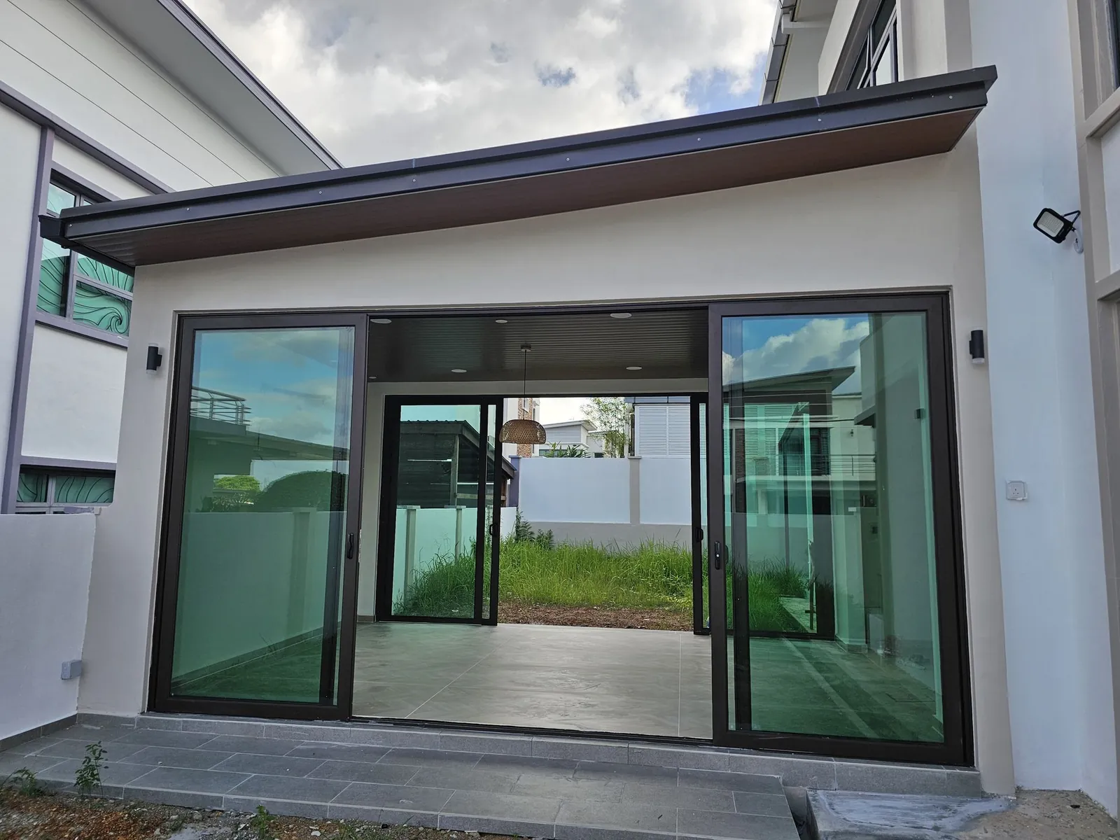 Finished rear extension with sliding glass doors at Paya Rumput Perdana