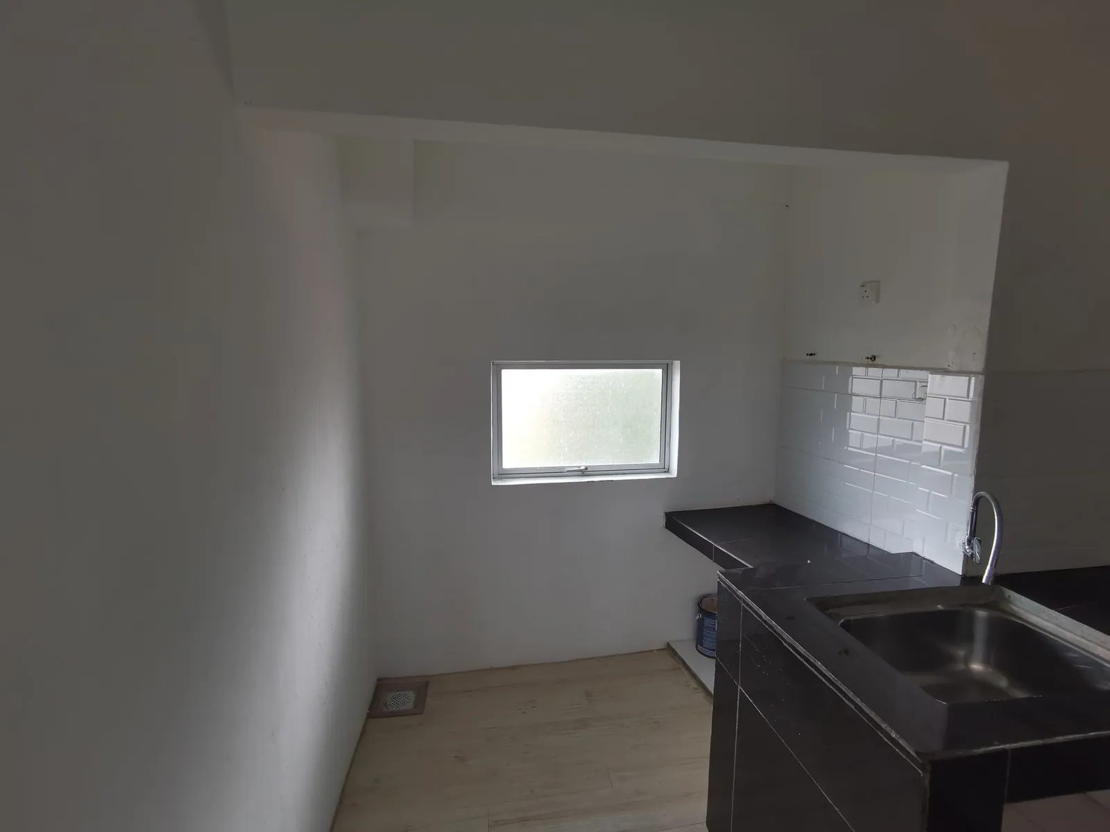 Taman Kesidang old kitchen with black tiled counter, sink and rear window