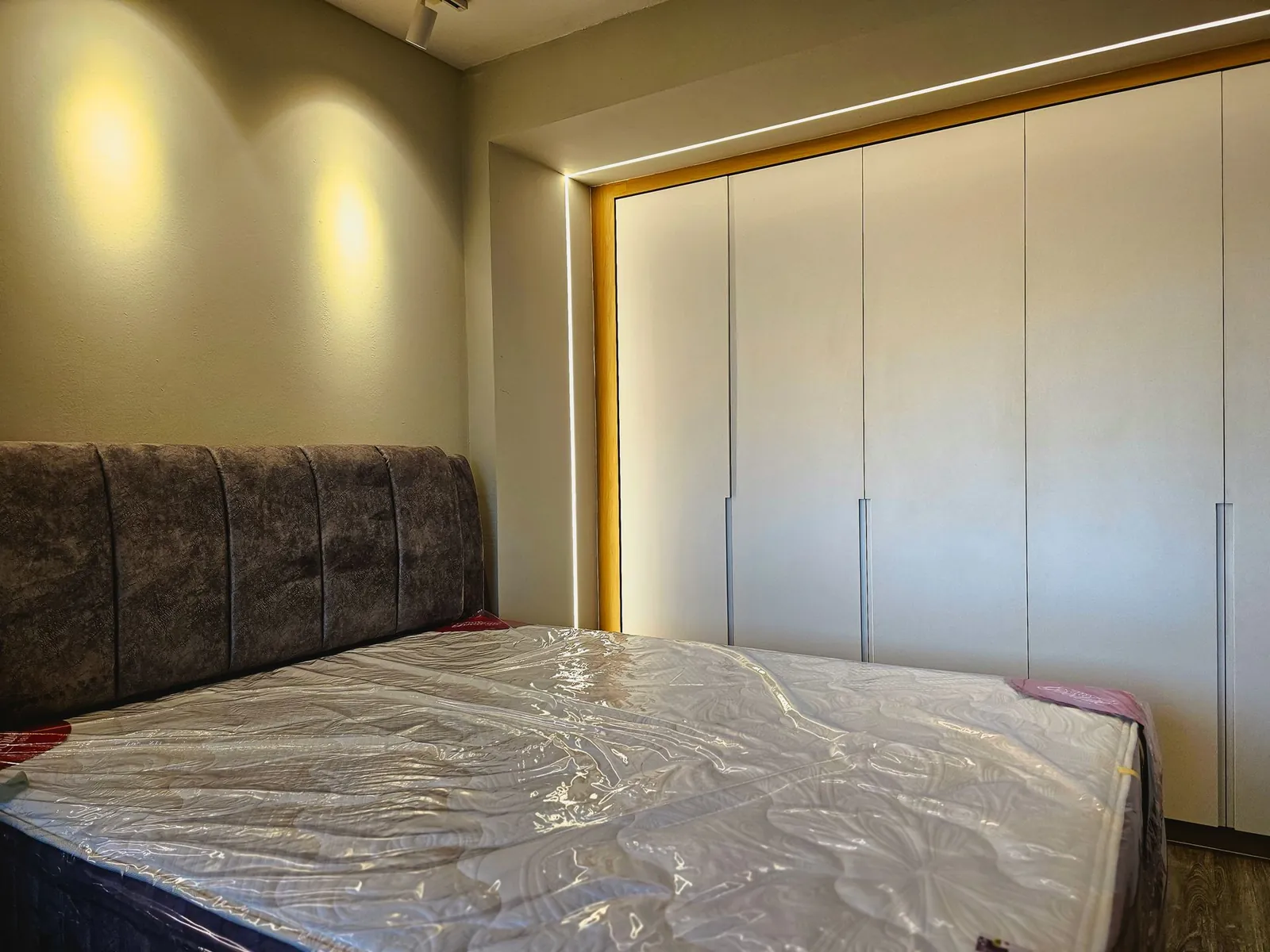 Taman Kesidang bedroom with built-in white wardrobe in an LED-lit frame