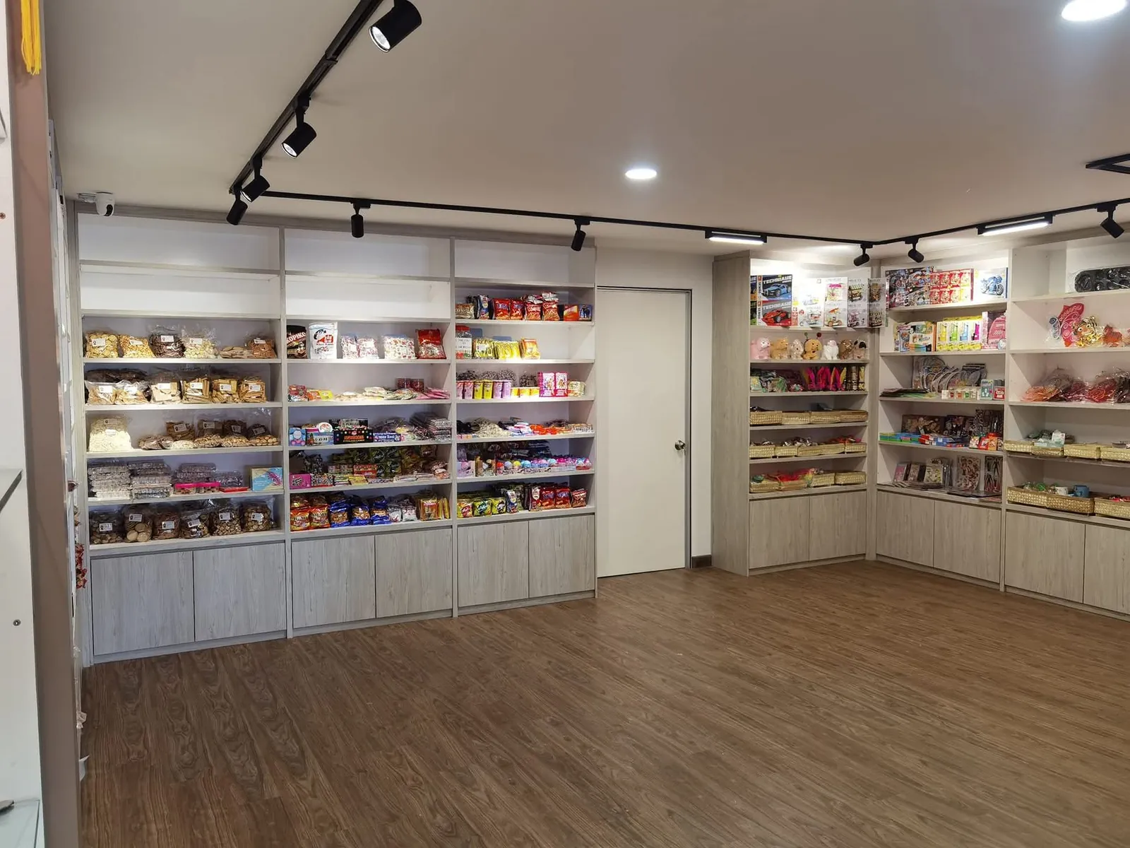 Wide view of perimeter shelving and wood-look floor at Ah Mok Shop