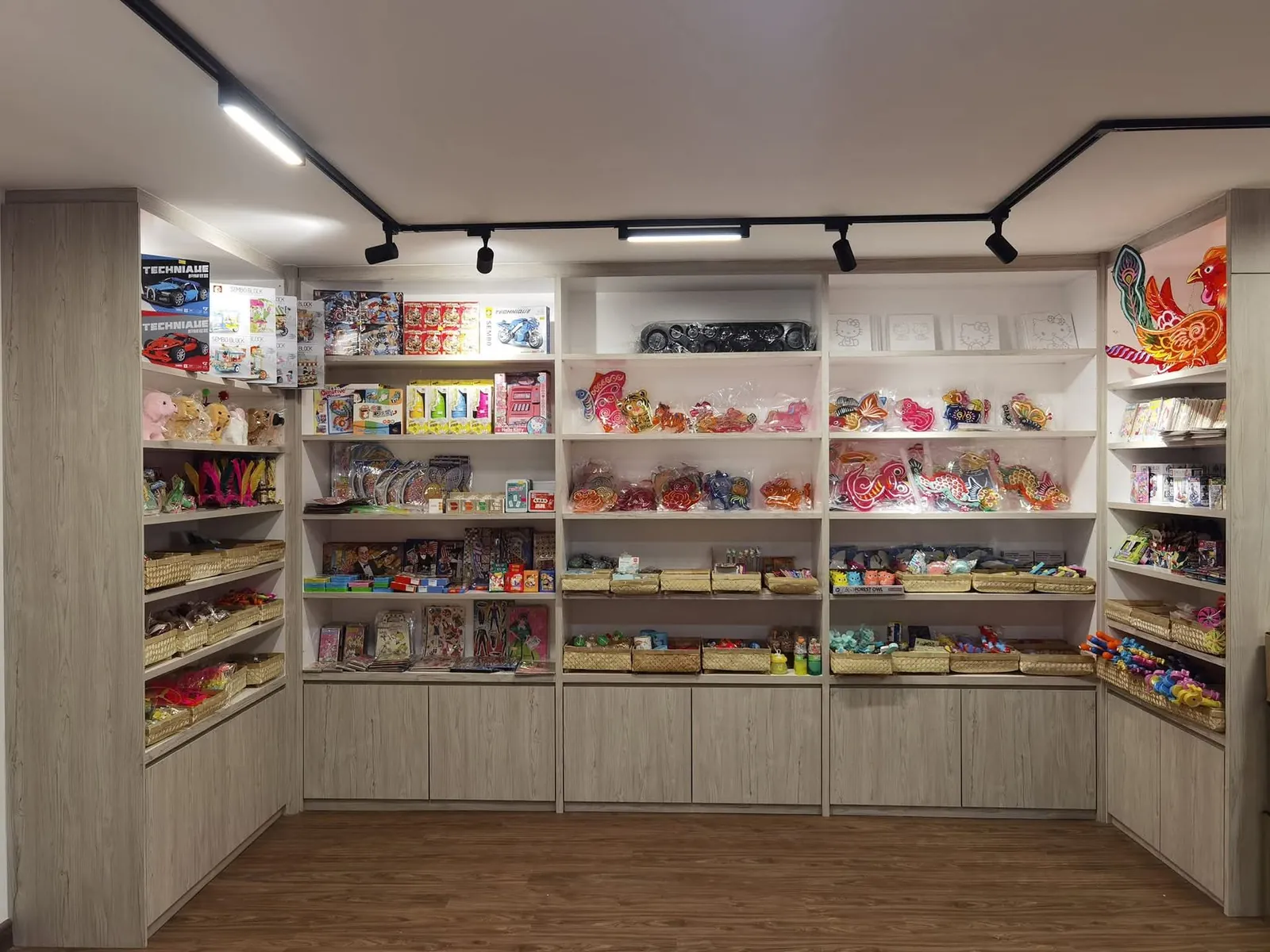 New white shelving wall with grey lower cabinets at Ah Mok Shop