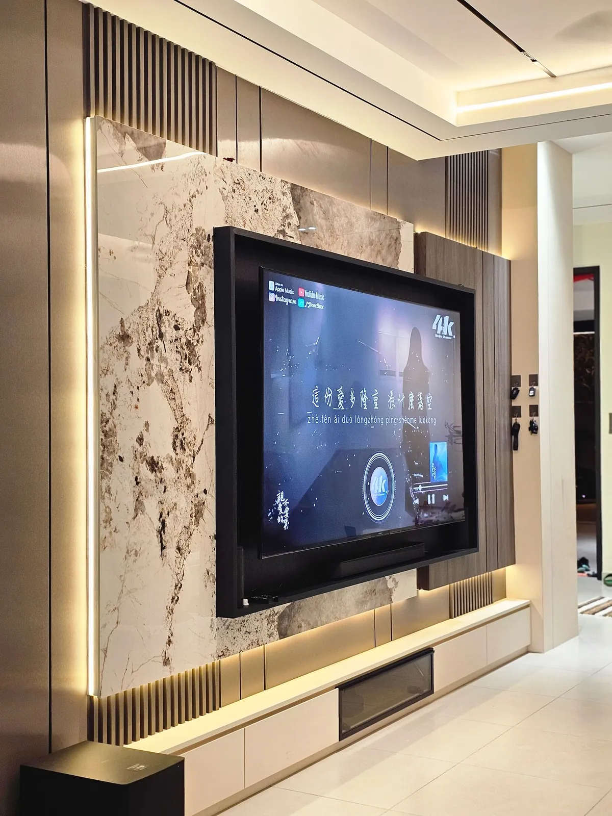 TV feature wall with stone-look panel, lit niche and floating console, Country Villa