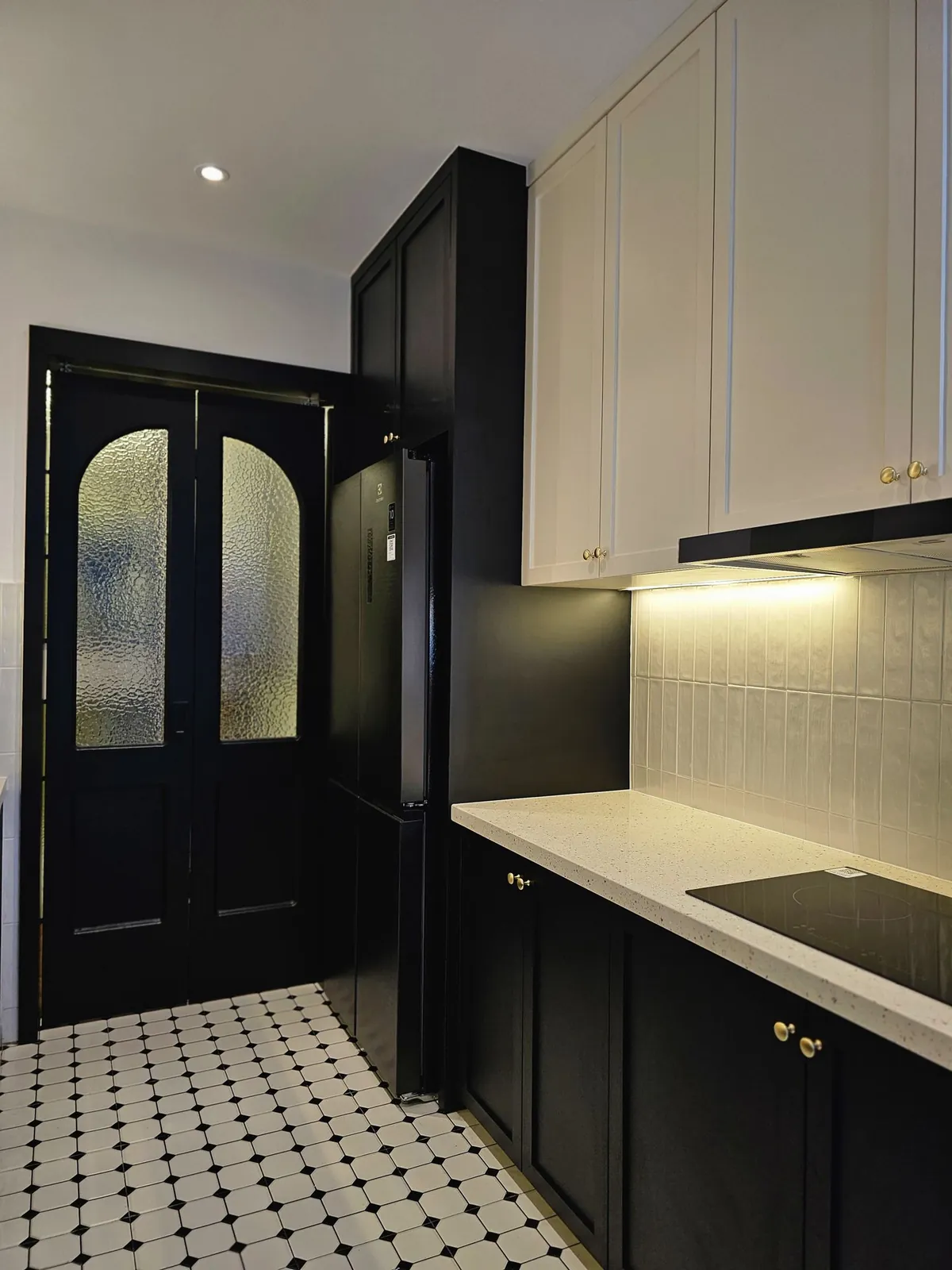 Bali Residence kitchen after, black arched double doors with textured glass