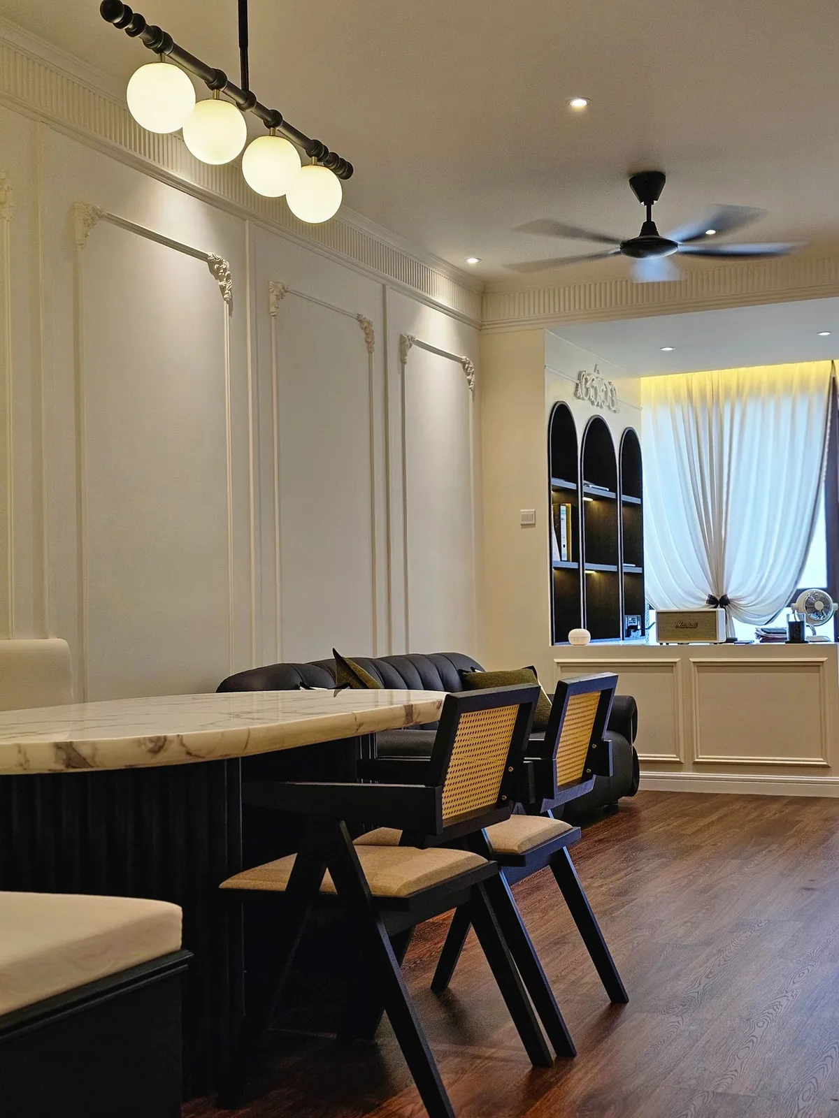 Dining area at Bali Residence, one of our Melaka renovation projects, with marble table and wall mouldings
