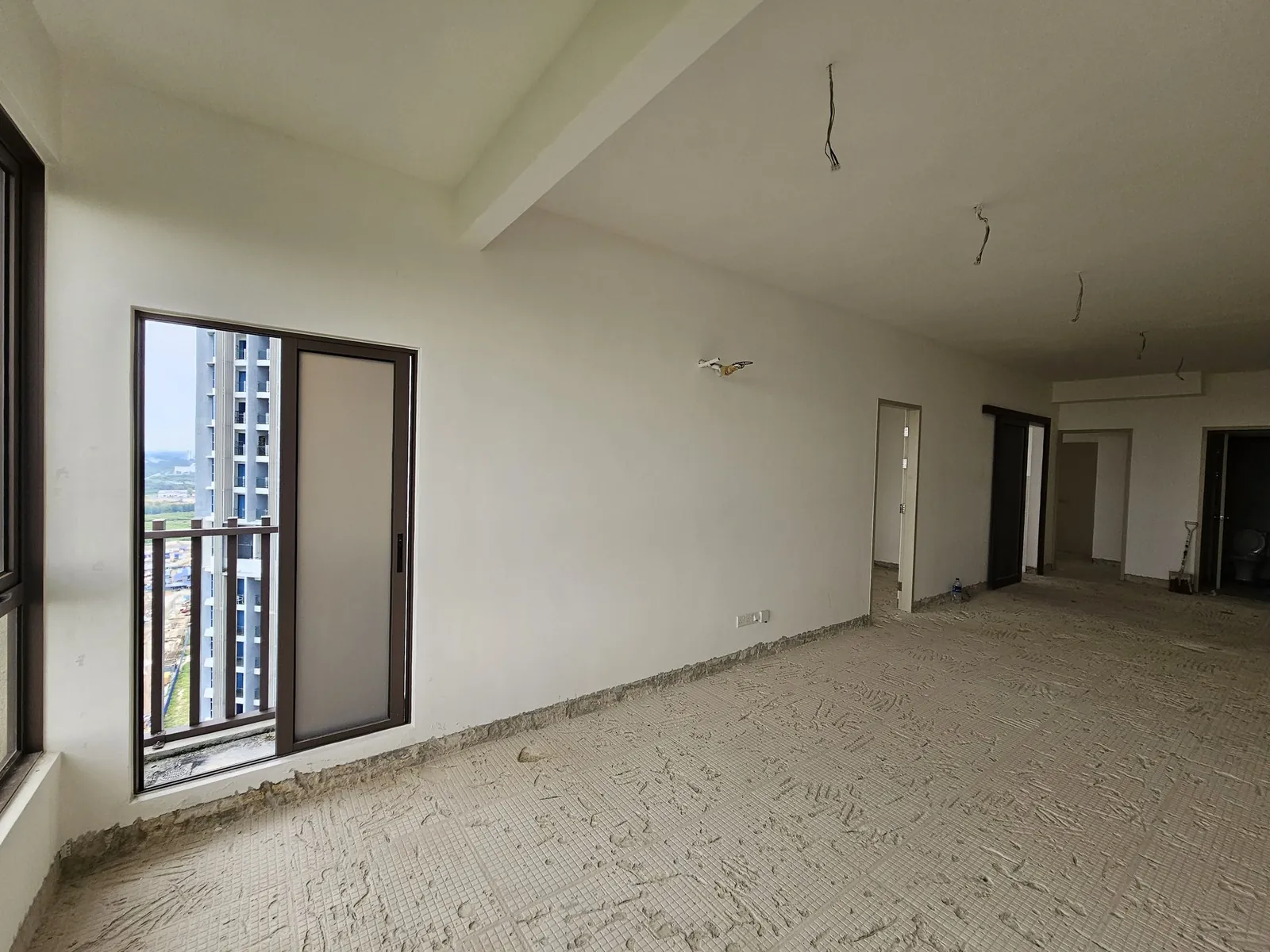 Bali Residence living area before work, bare screed floor and ceiling wires