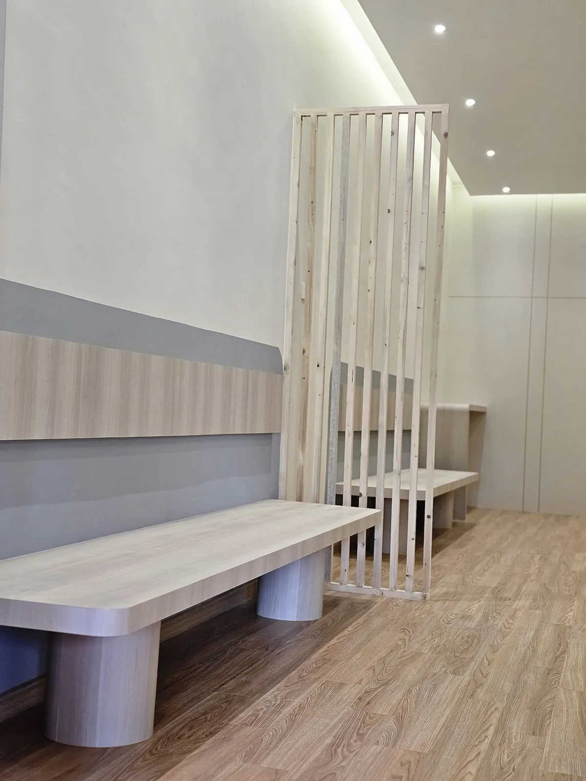 Kimvets Krubong timber-tone bench with round legs beside a slat screen