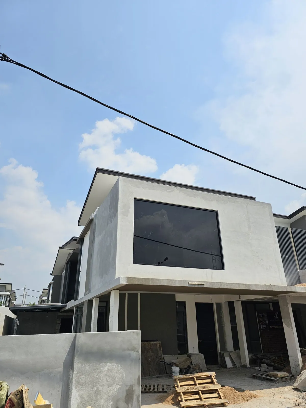 Plastered first-floor extension with its large black-framed window fitted, Country Villa