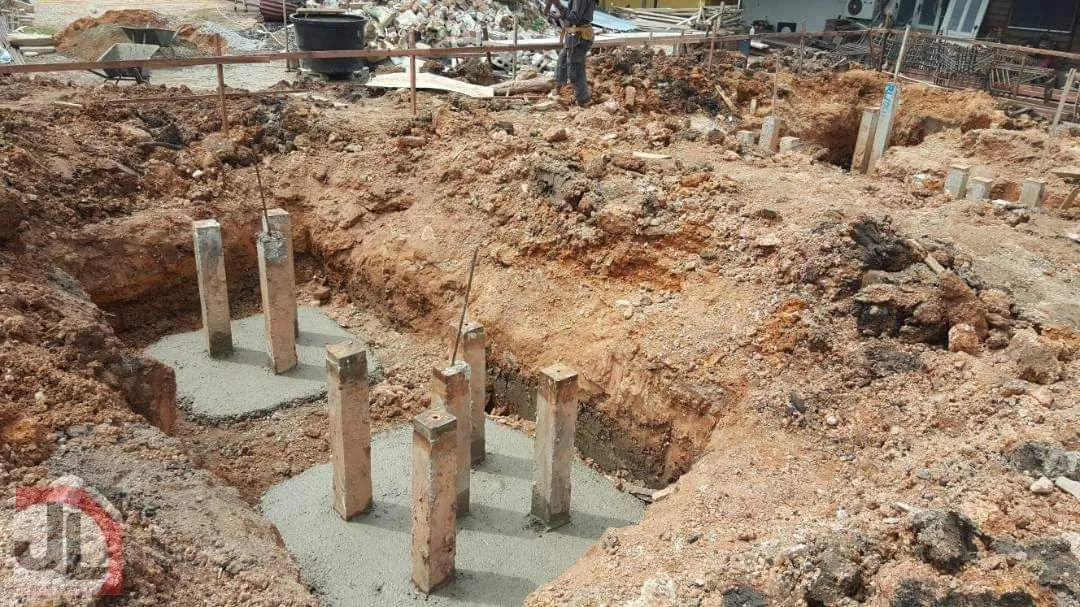 Bachang Temple Office Building excavated pits with short stumps on fresh concrete bases