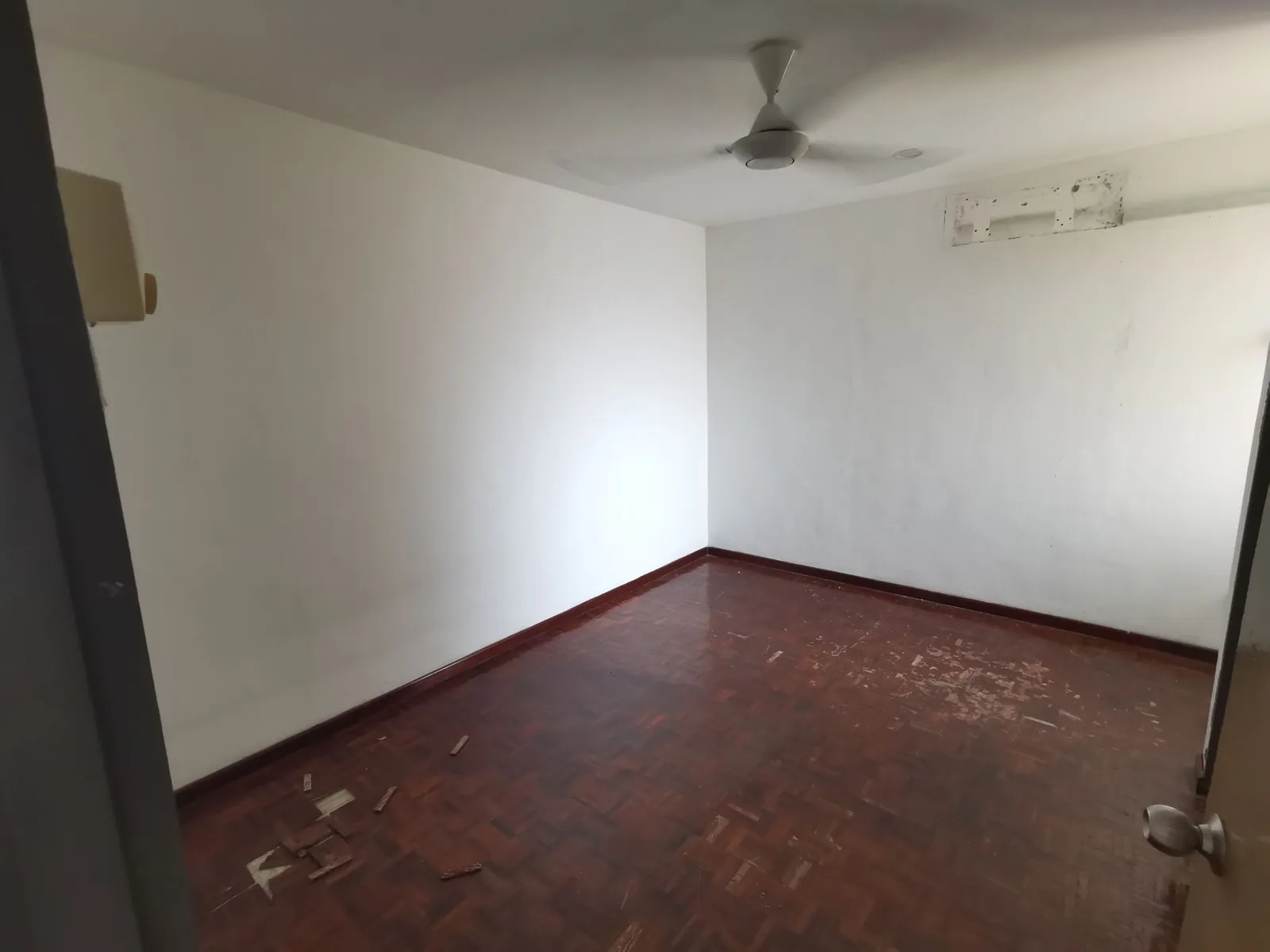 Taman Kesidang empty bedroom before, with worn parquet floor