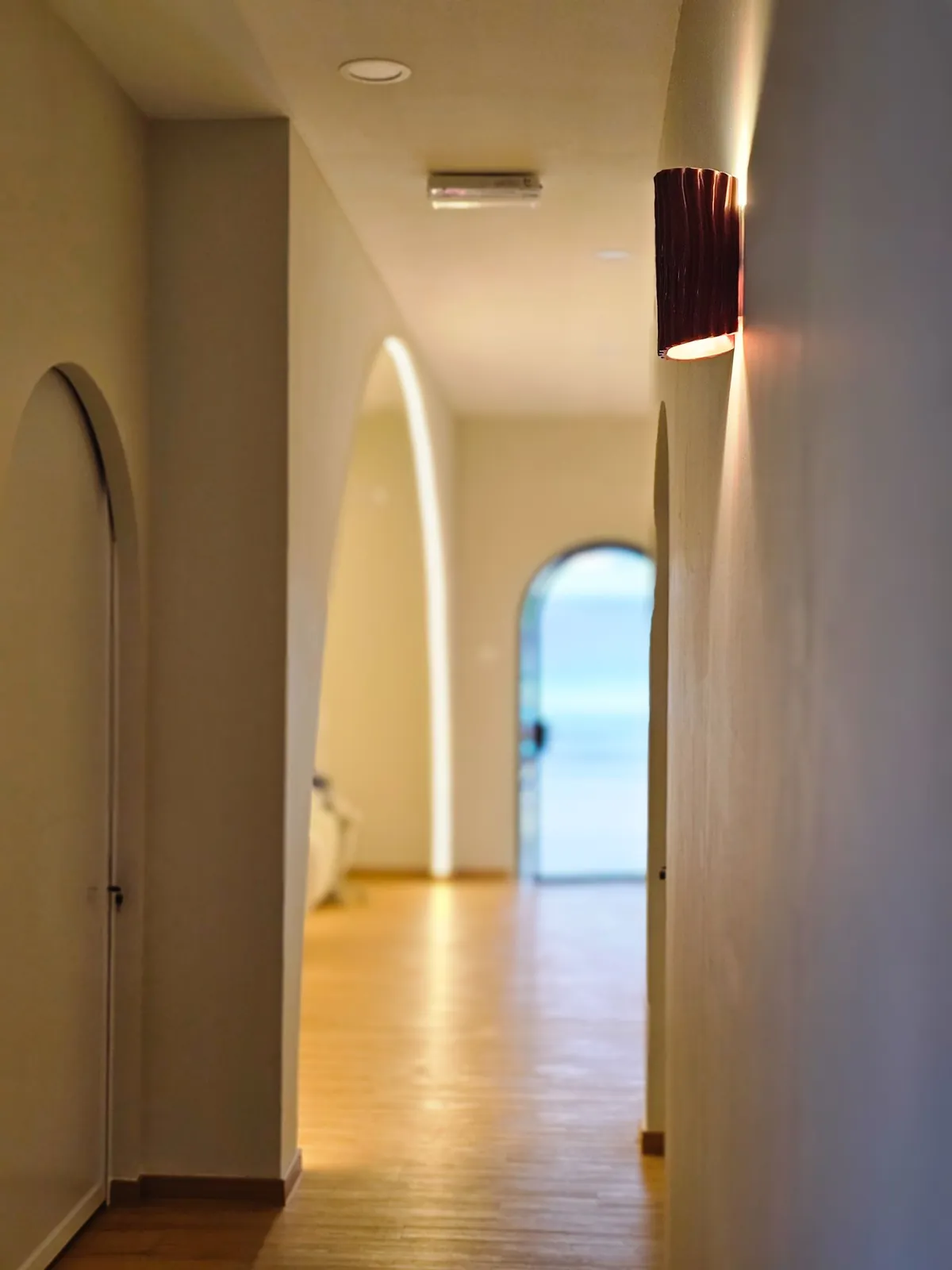 Good Skin Bar corridor with arched openings, LED edge light and sconce