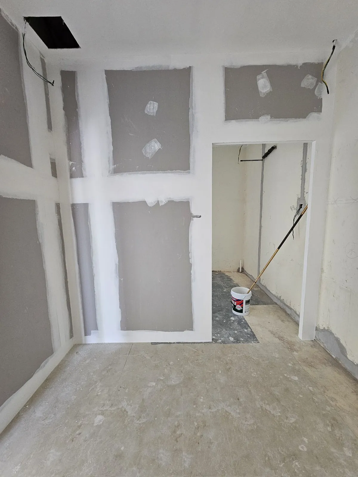 Kimvets Krubong room with patched gypsum walls and open ceiling hatch