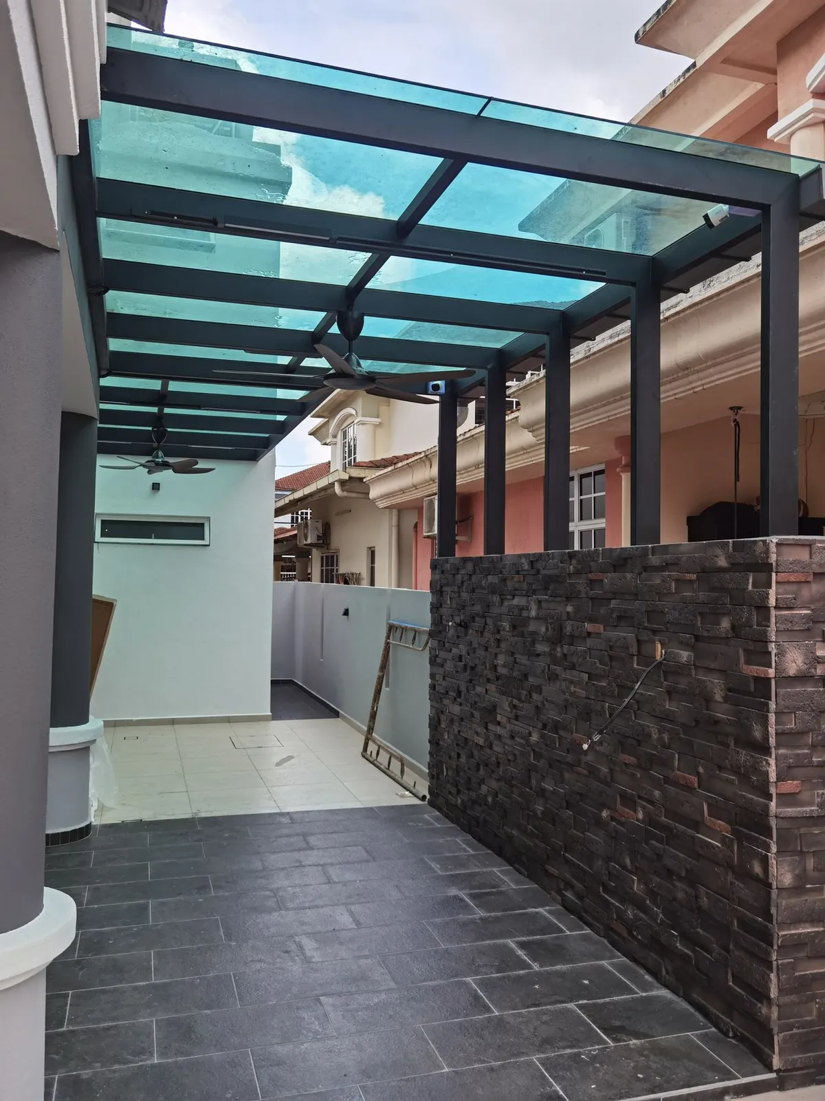 Taman Ara Permai glass-roof awning on black steel frame over slate tiles