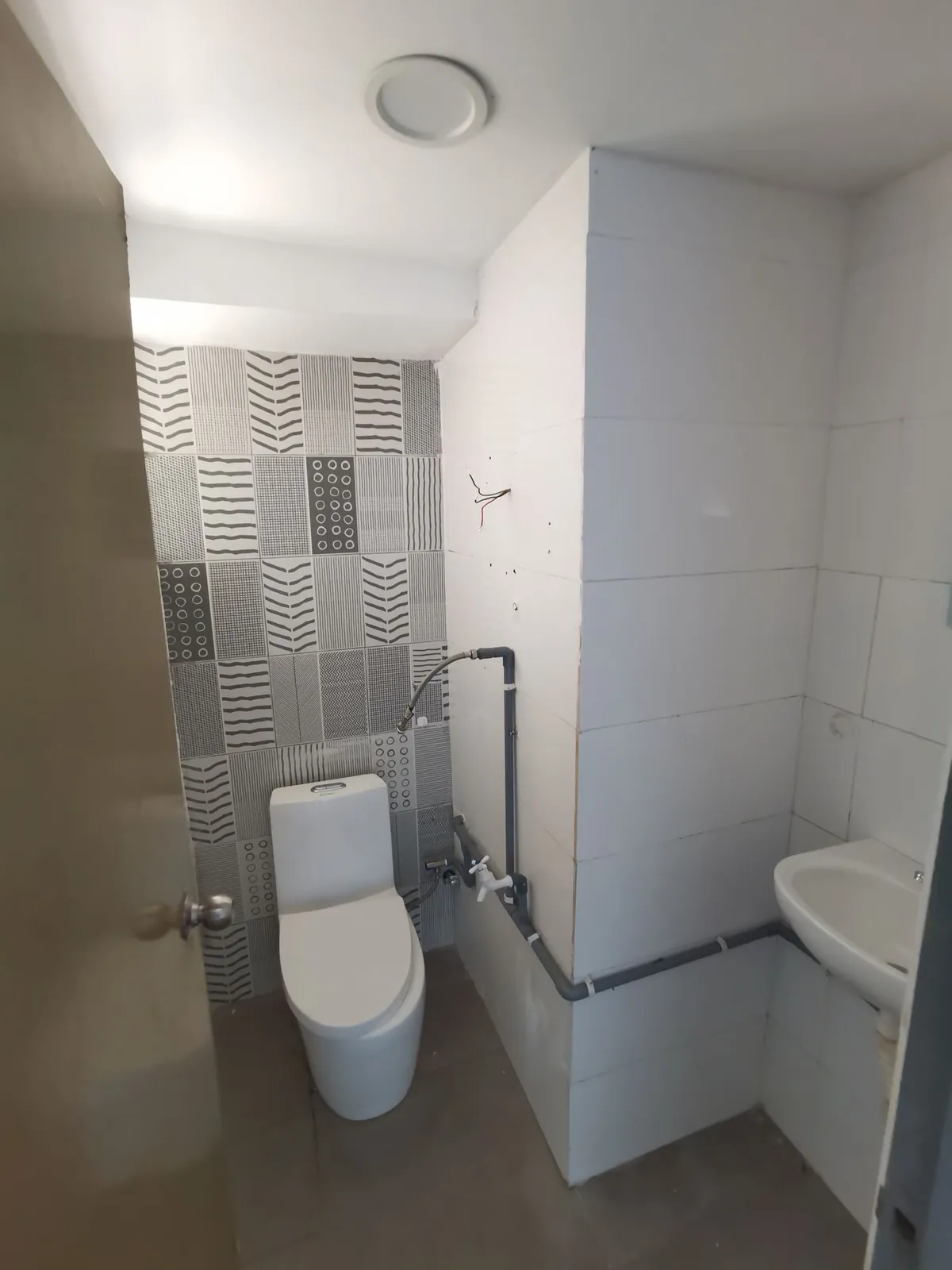Taman Kesidang old bathroom with patterned tiles and exposed pipes