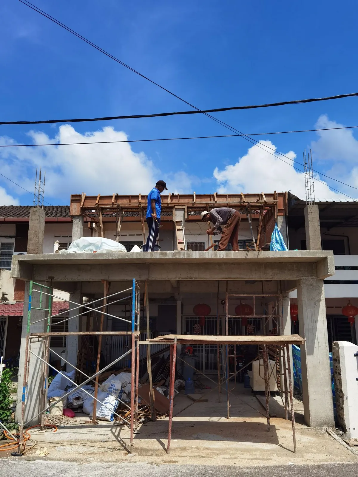 Concrete porch frame with scaffolding during the car porch extension at Taman Asean