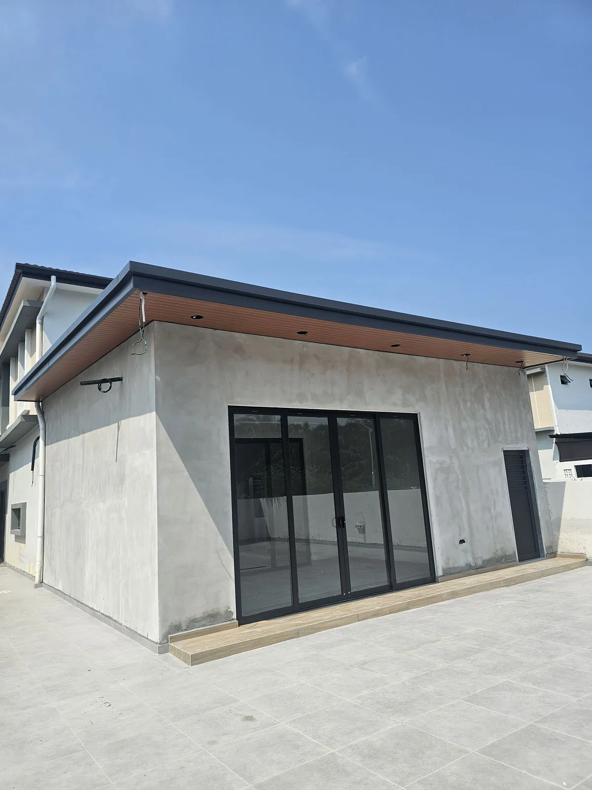 Jasin Parkland extension exterior with sliding glass doors and a tiled yard