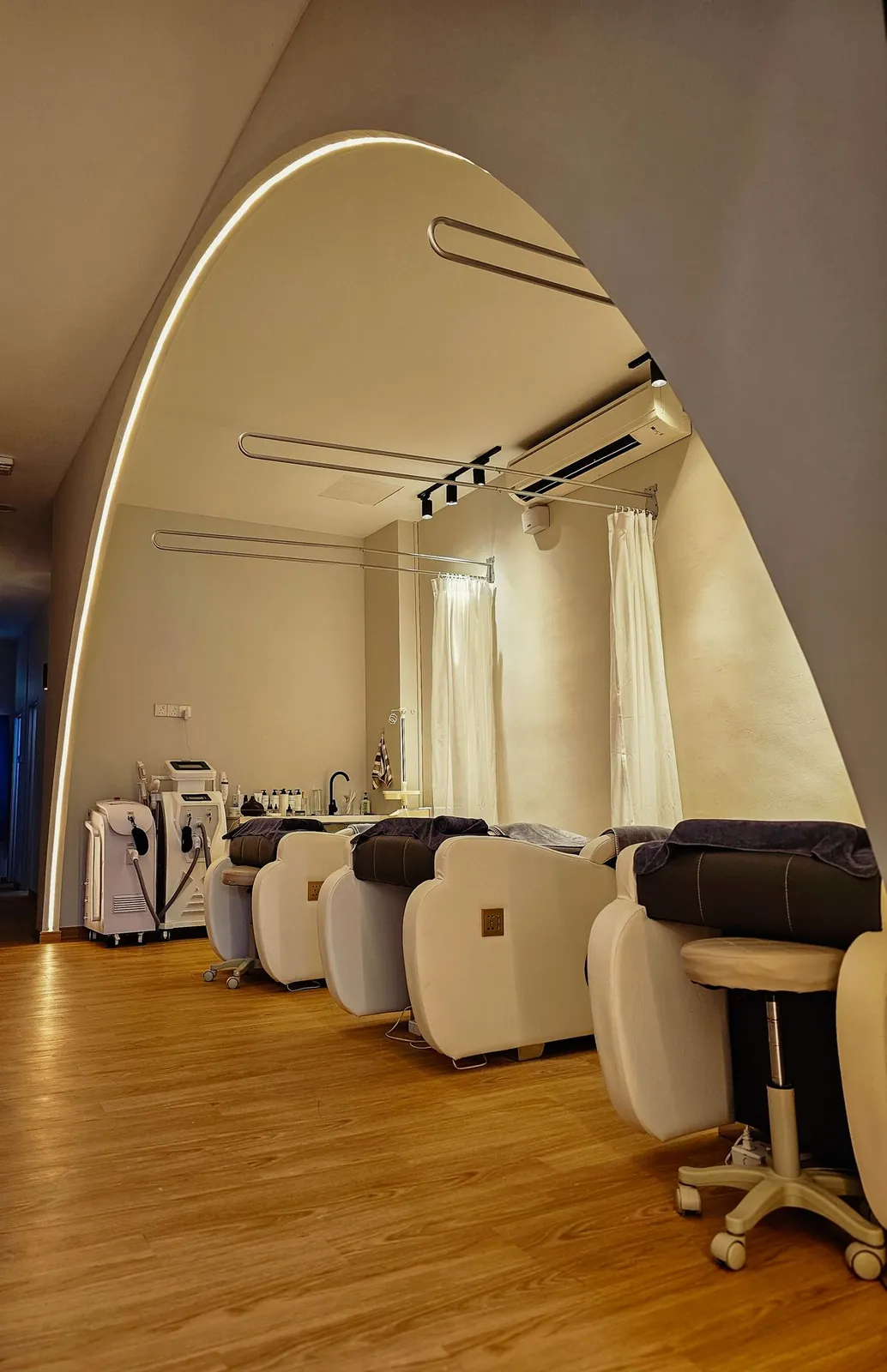LED-outlined arch framing a row of facial beds at Good Skin Bar