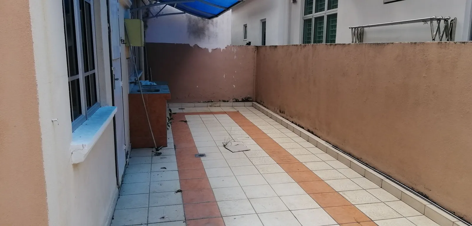 Taman Ara Permai narrow back yard before works, under a blue awning