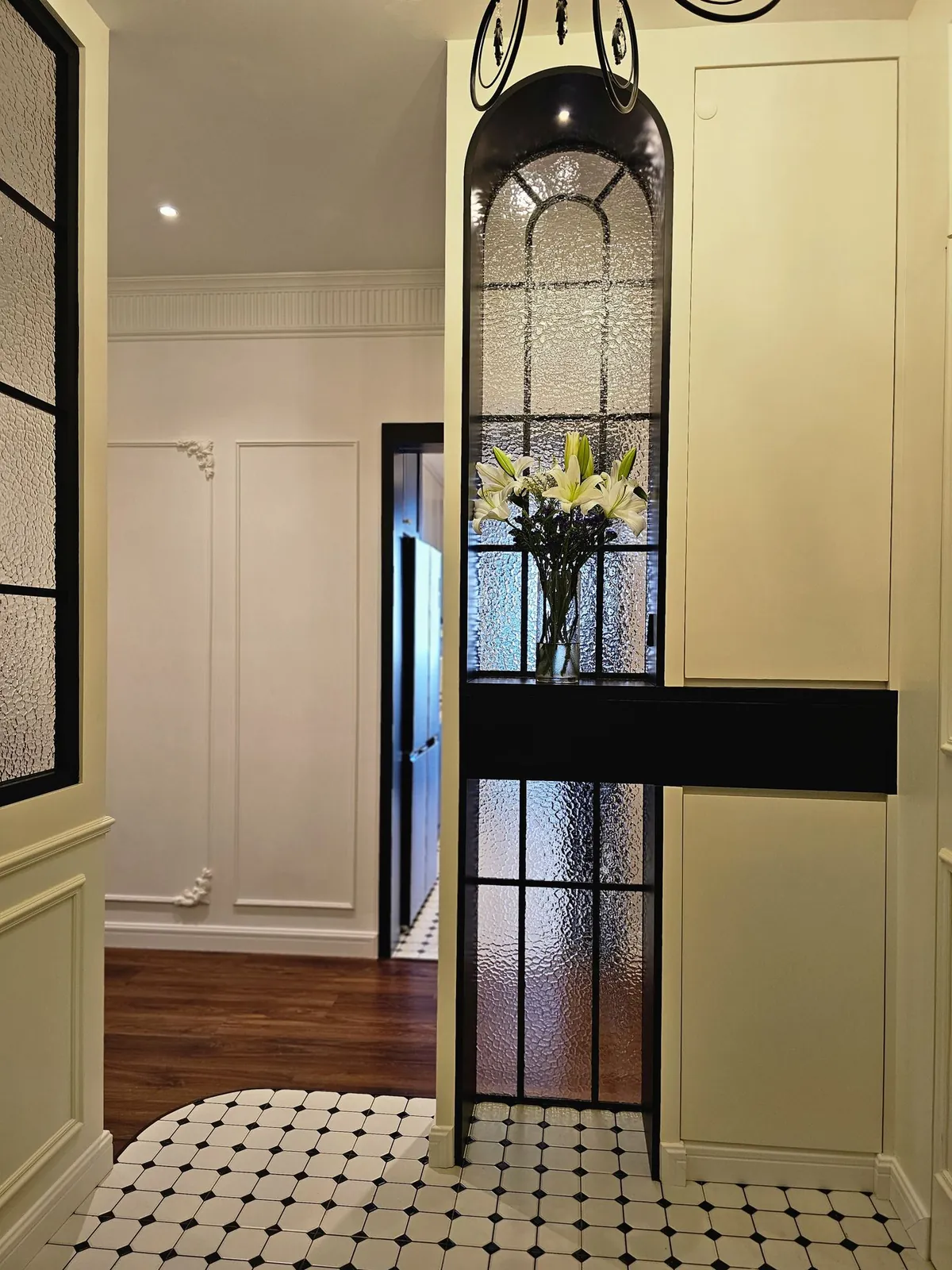 Bali Residence foyer with arched textured glass screen and octagon floor tiles