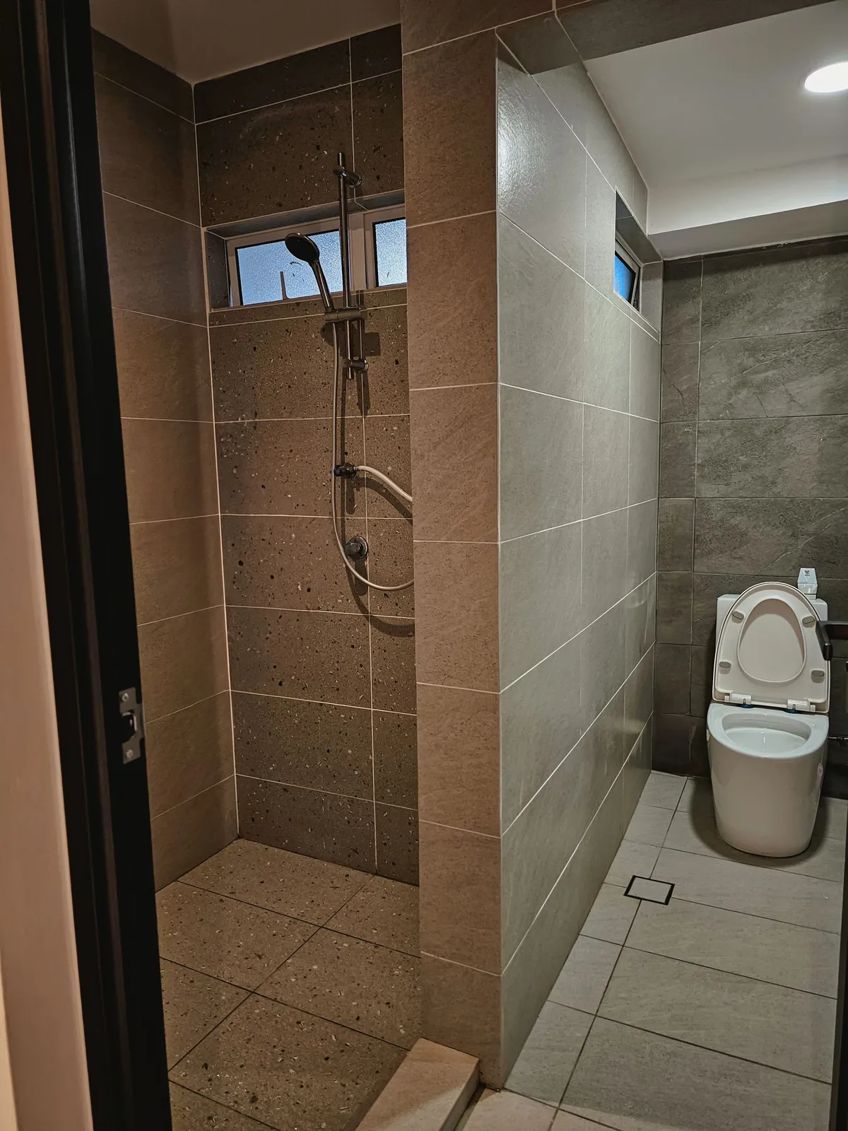 Taman Kesidang re-tiled bathroom with stone-look tiles and shower area