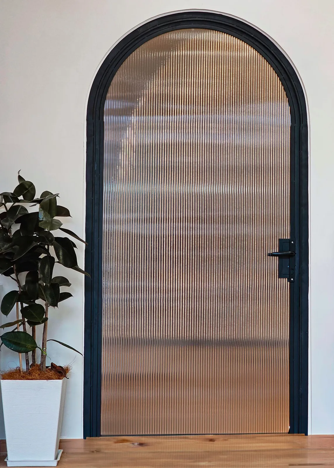 Good Skin Bar arched black-framed door with fluted glass