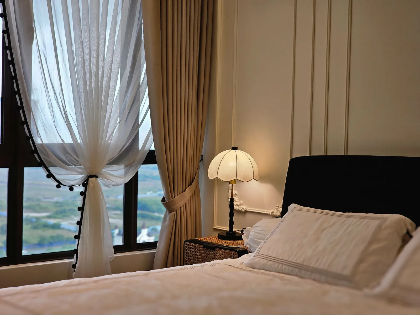 Bali Residence bedroom with moulded wall panels and layered curtains